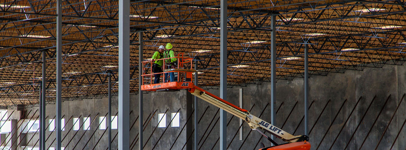 Workers on a lift in a new warehouse