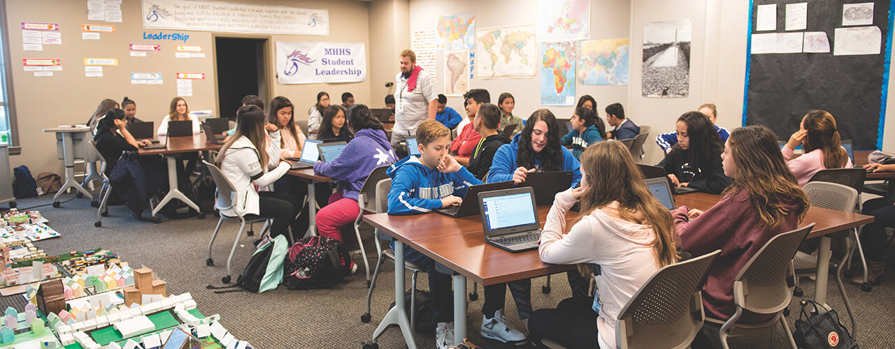 Classroom with children working on laptops