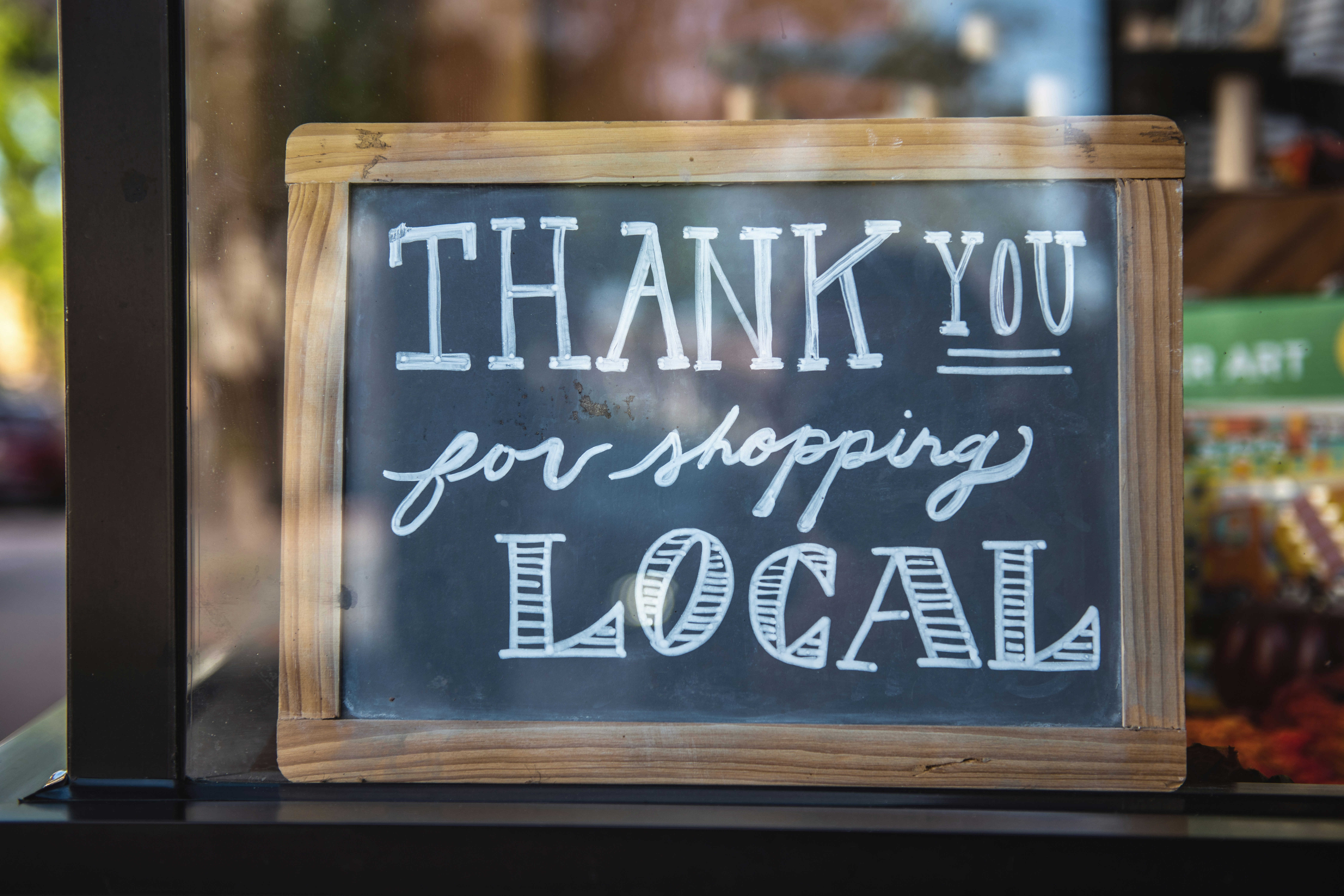 Thank you for shopping local sign in shop window