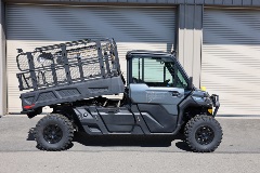 Side profile of black UTV#2 with lifted bed cage
